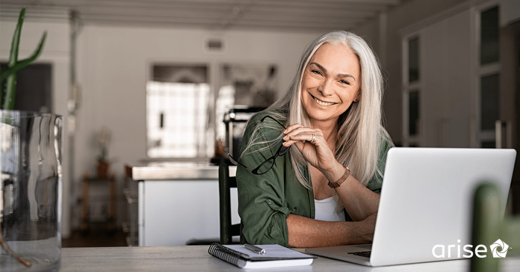 Smiling woman working on a computer.