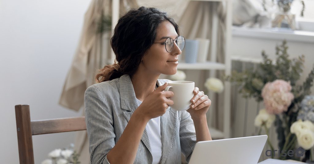 Smiling woman drinking coffee.