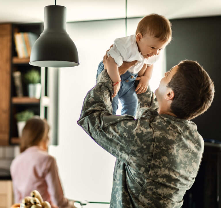Military family with child in a kitchen.