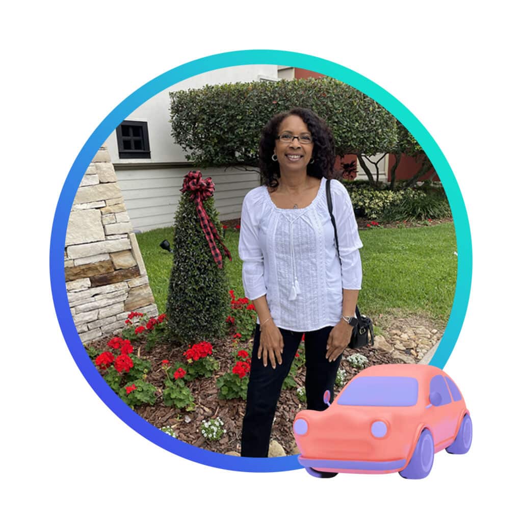 Smiling woman in front of red flowers and an image of a car in the lower right.