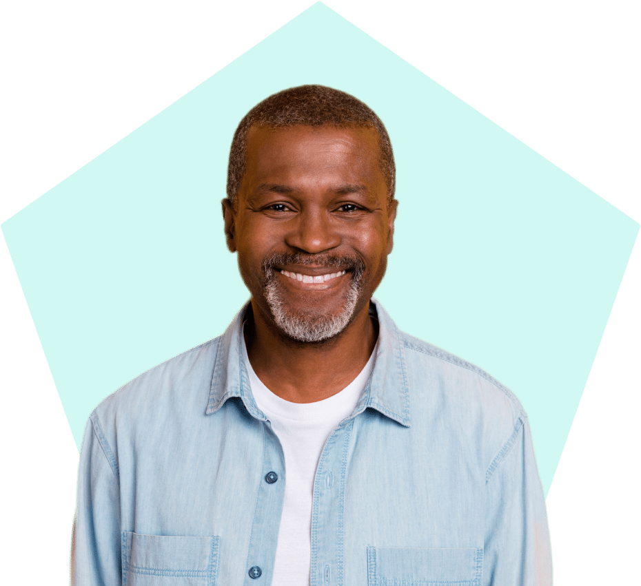 Smiling man wearing a denim shirt.