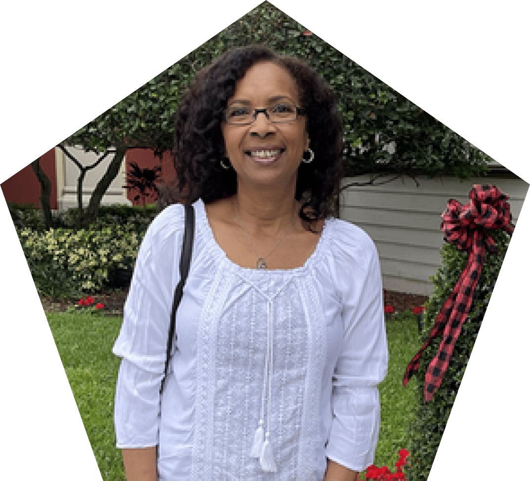 Smiling woman wearing glasses and white shirt.