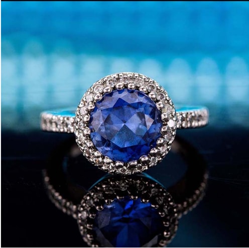 Round sapphire and diamond ring.