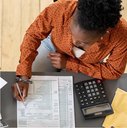 Woman working on taxes.