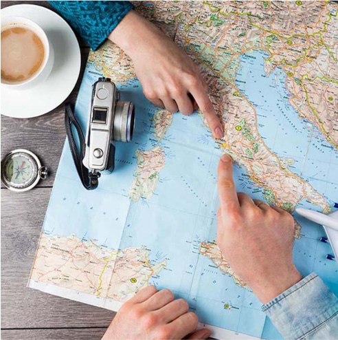People pointing at a map of Italy.