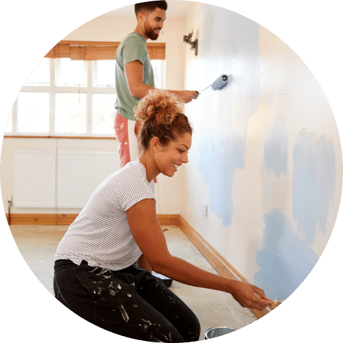 Man and woman painting a wall.