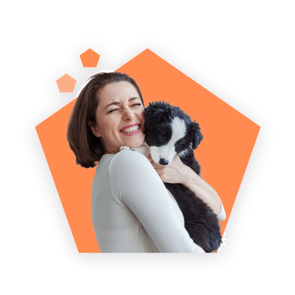 Woman holding and hugging a puppy.