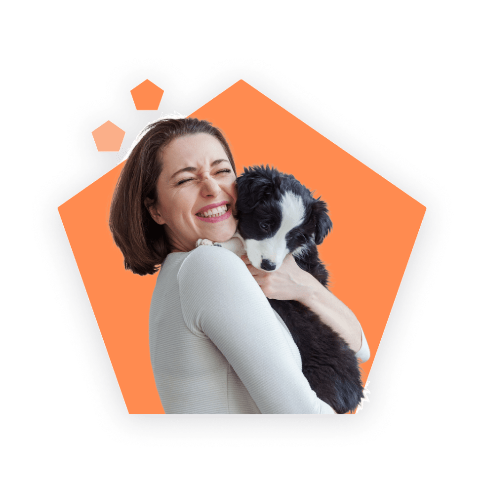 Woman holding and hugging a puppy.