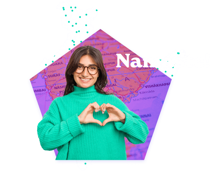 Smiling woman wearing glasses standing in front of a map of India.