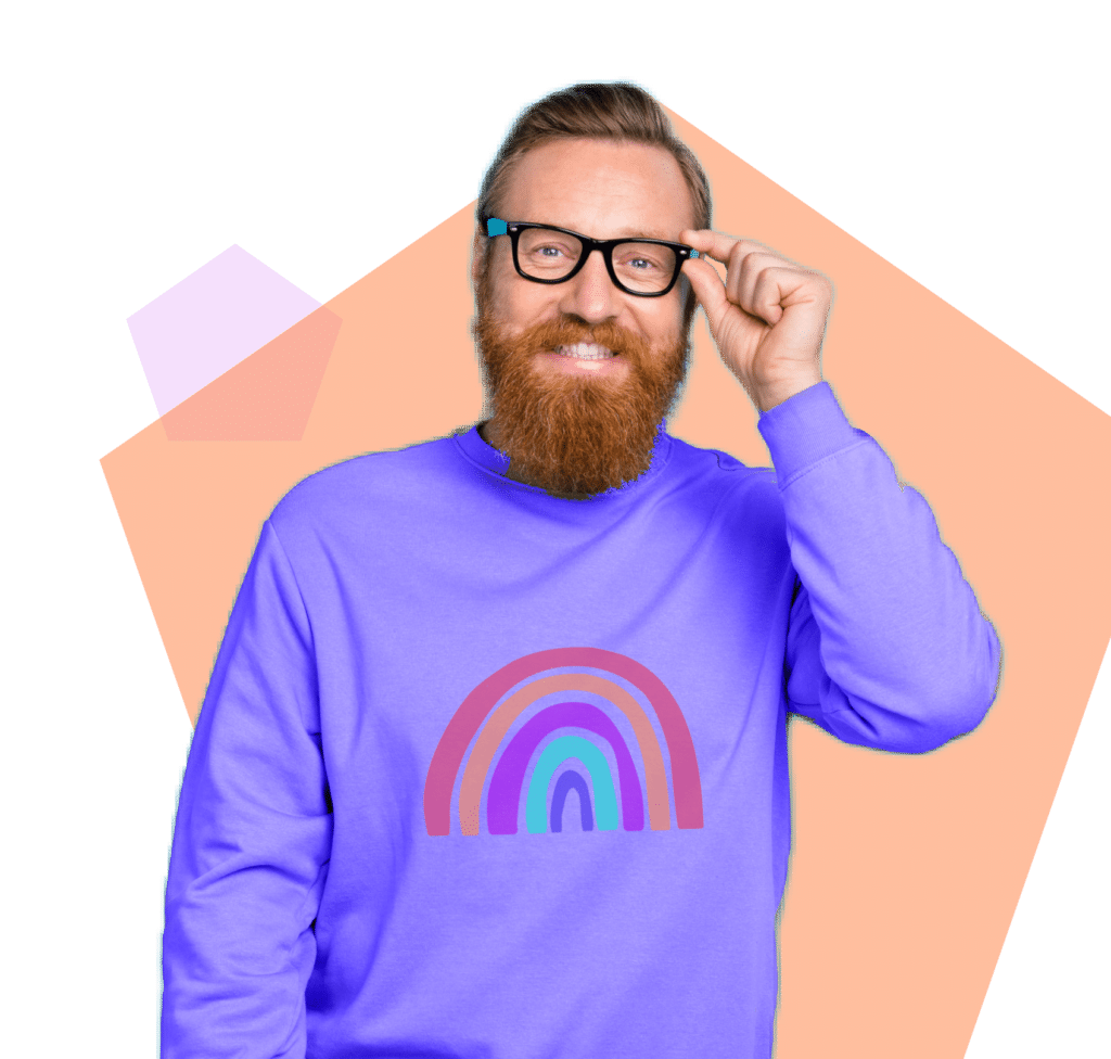 Smiling man wearing a purple shirt with a rainbow and glasses.
