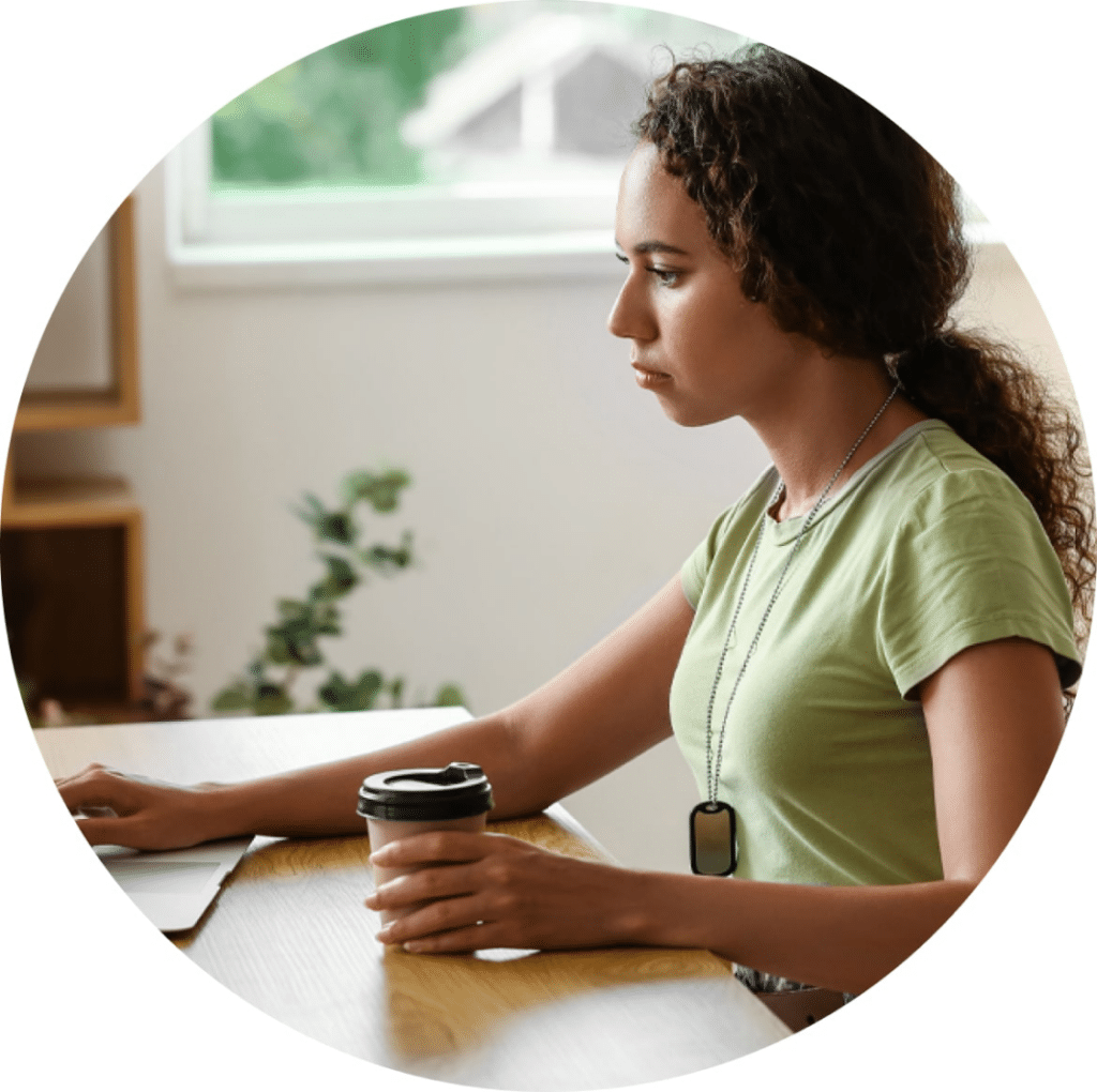 Serious looking woman working on a laptop.