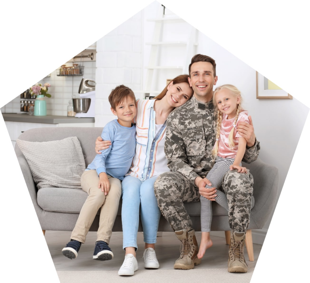 Smiling military family sitting on a couch.