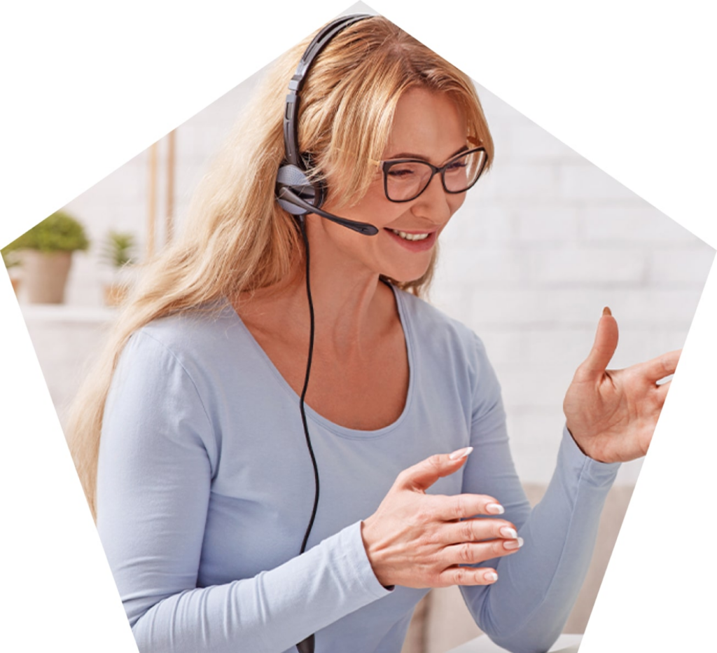 Smiling woman wearing headset holding hands out.