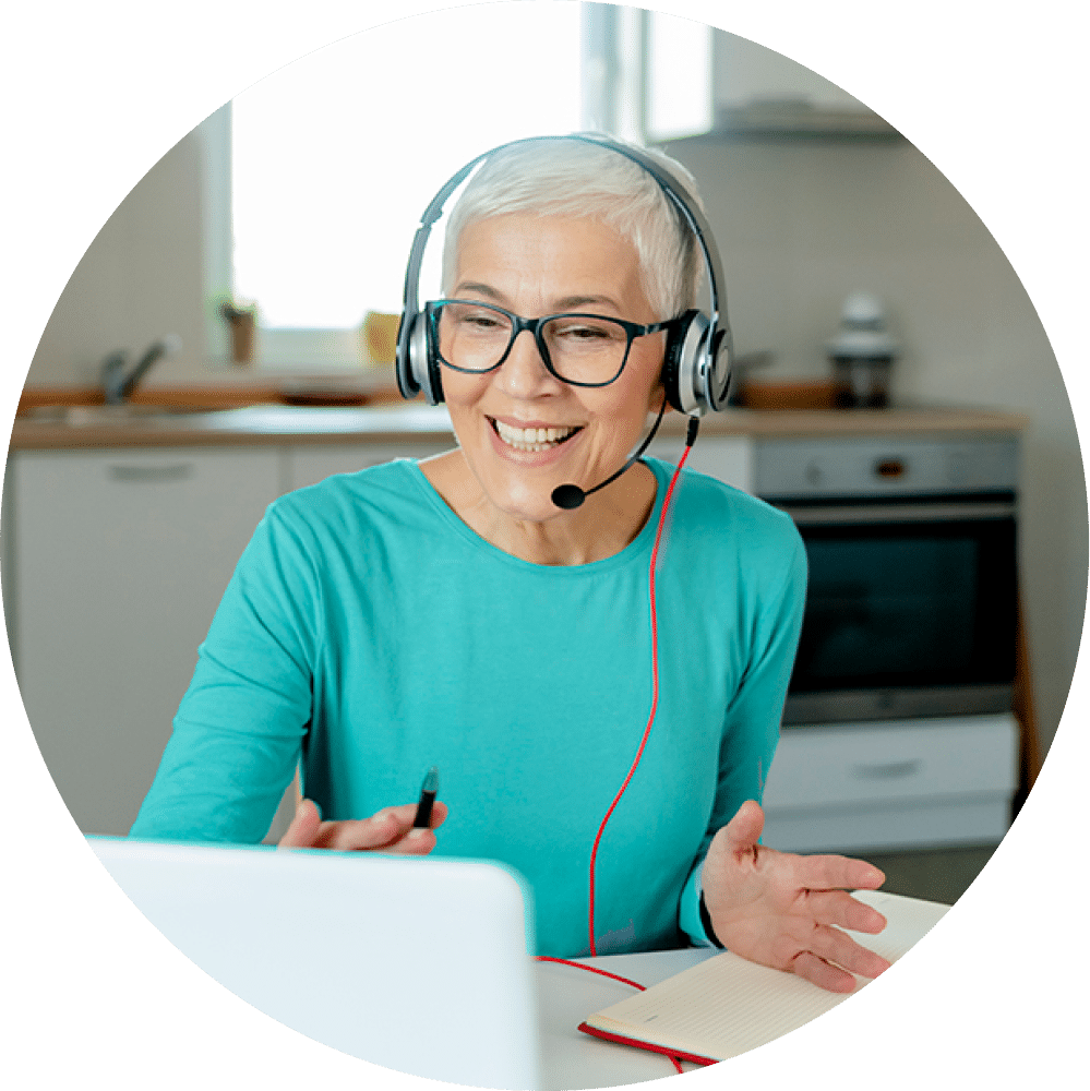 Smiling woman wearing headset and glasses.
