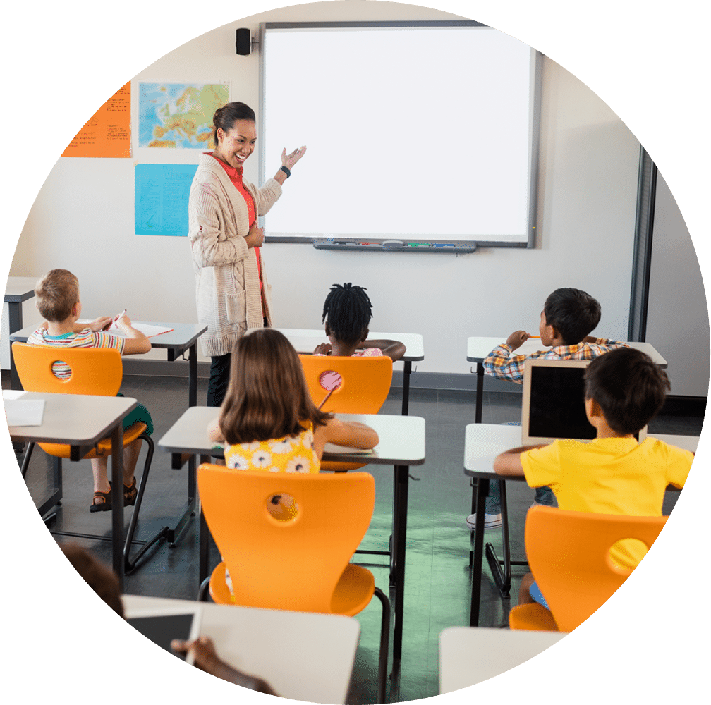 Teacher in front of a classroom of children.